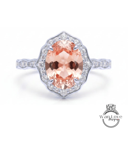 A beautiful engagement ring with a large oval-shaped gemstone surrounded by a halo of smaller diamonds set in a silver band.