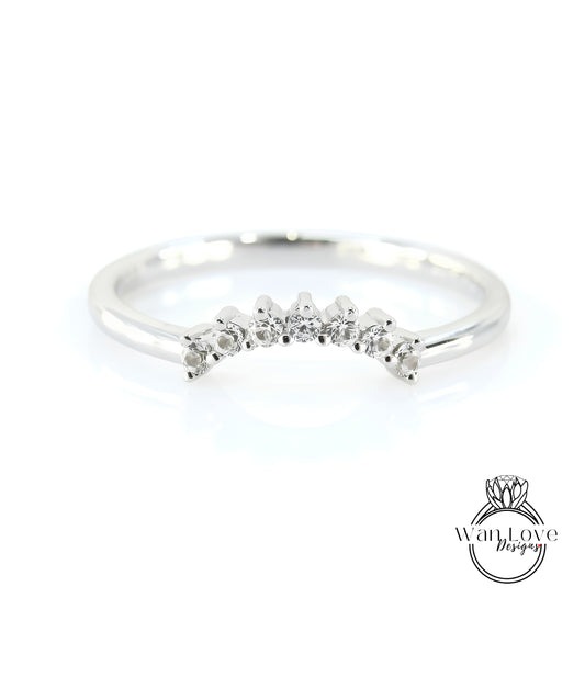 A silver ring with a row of small diamonds set in the center.
