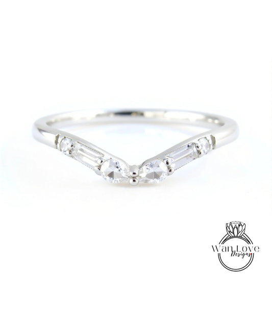 A silver ring with a v-shaped band and two large, clear gemstones.