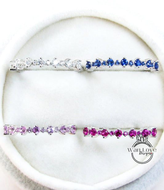 a collection of four silver and four pink gemstone bracelets arranged on a white surface.