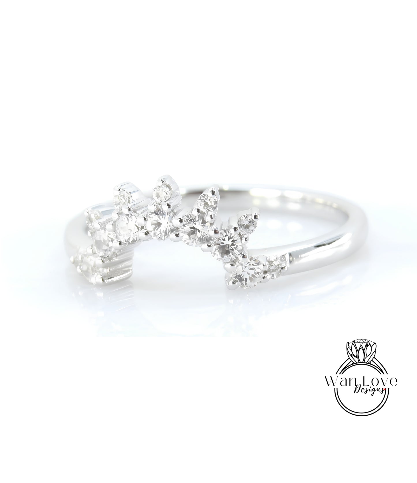 A silver ring with a decorative design featuring small diamonds or gemstones.