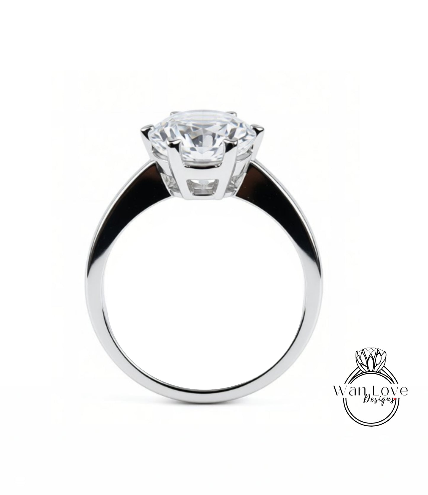 A close-up of a silver ring with a large, clear gemstone set in the center.