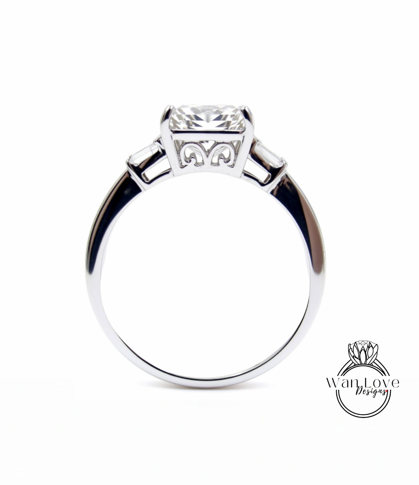 A silver engagement ring with a large central diamond and three smaller diamonds on either side.