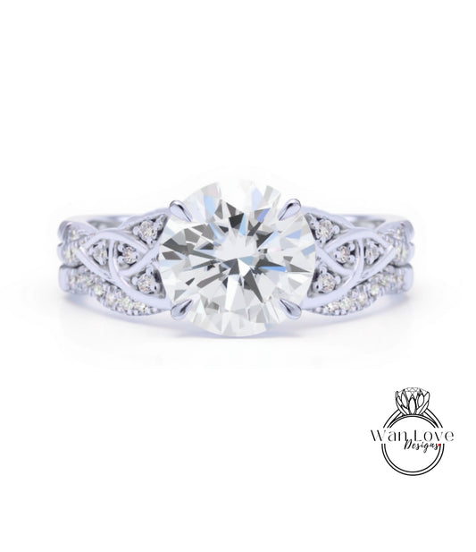A close-up of a diamond engagement ring with a large central diamond surrounded by smaller diamonds on either side.