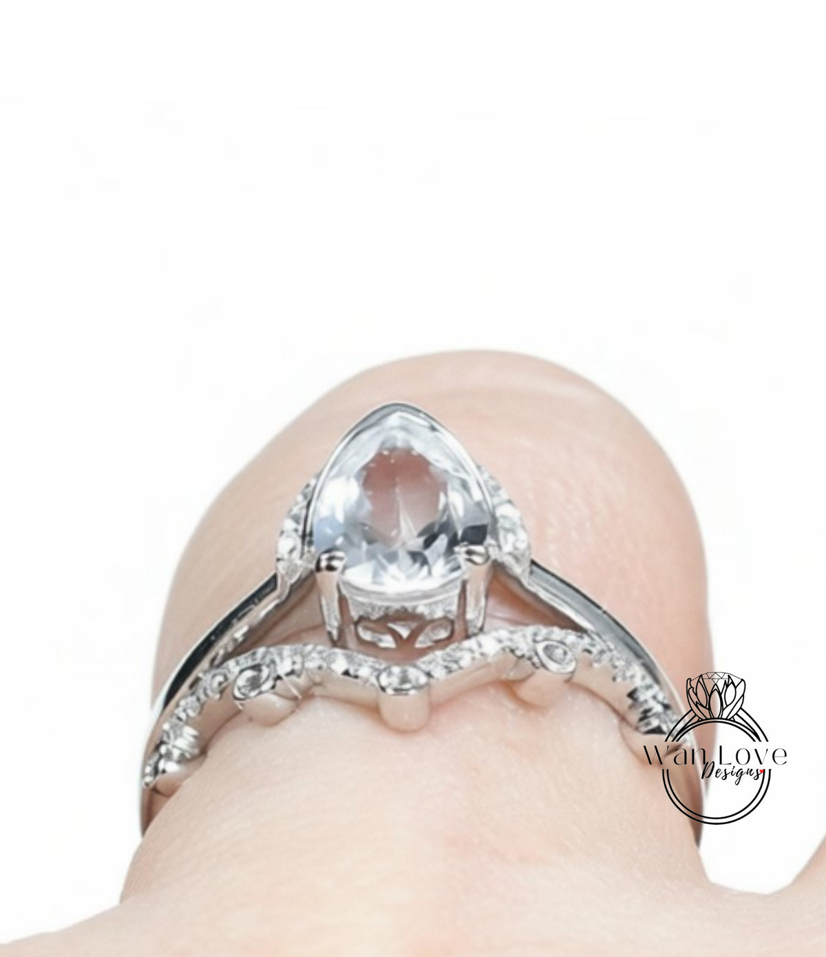 A close-up view of a diamond engagement ring on a person's finger, showcasing the intricate design and sparkling gemstone.