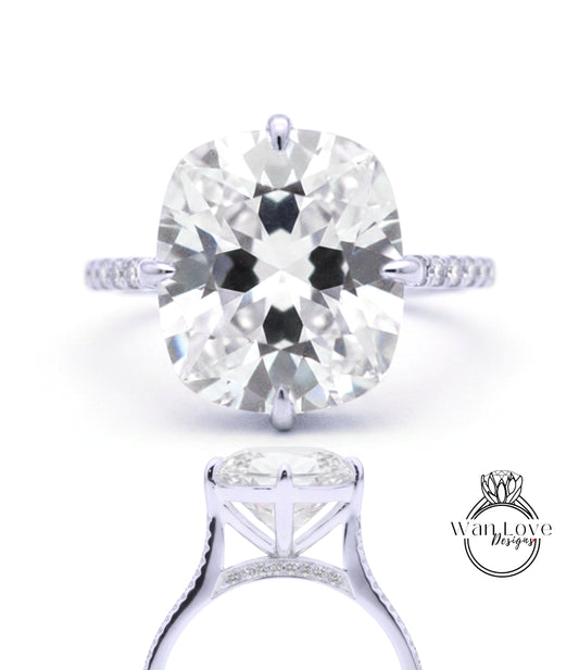 A large, round diamond engagement ring with a silver band and pavé setting.
