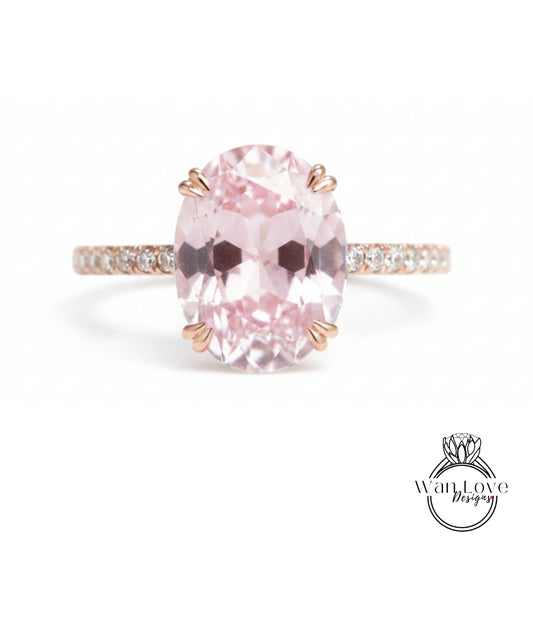 A pink gemstone engagement ring with a large oval-shaped gemstone set in a rose gold band.
