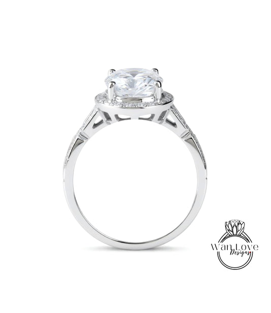 A silver engagement ring with a large central diamond surrounded by smaller diamonds.
