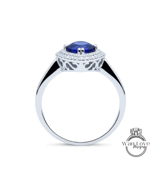 A silver ring with a large blue gemstone set in the center, surrounded by a decorative metal band.