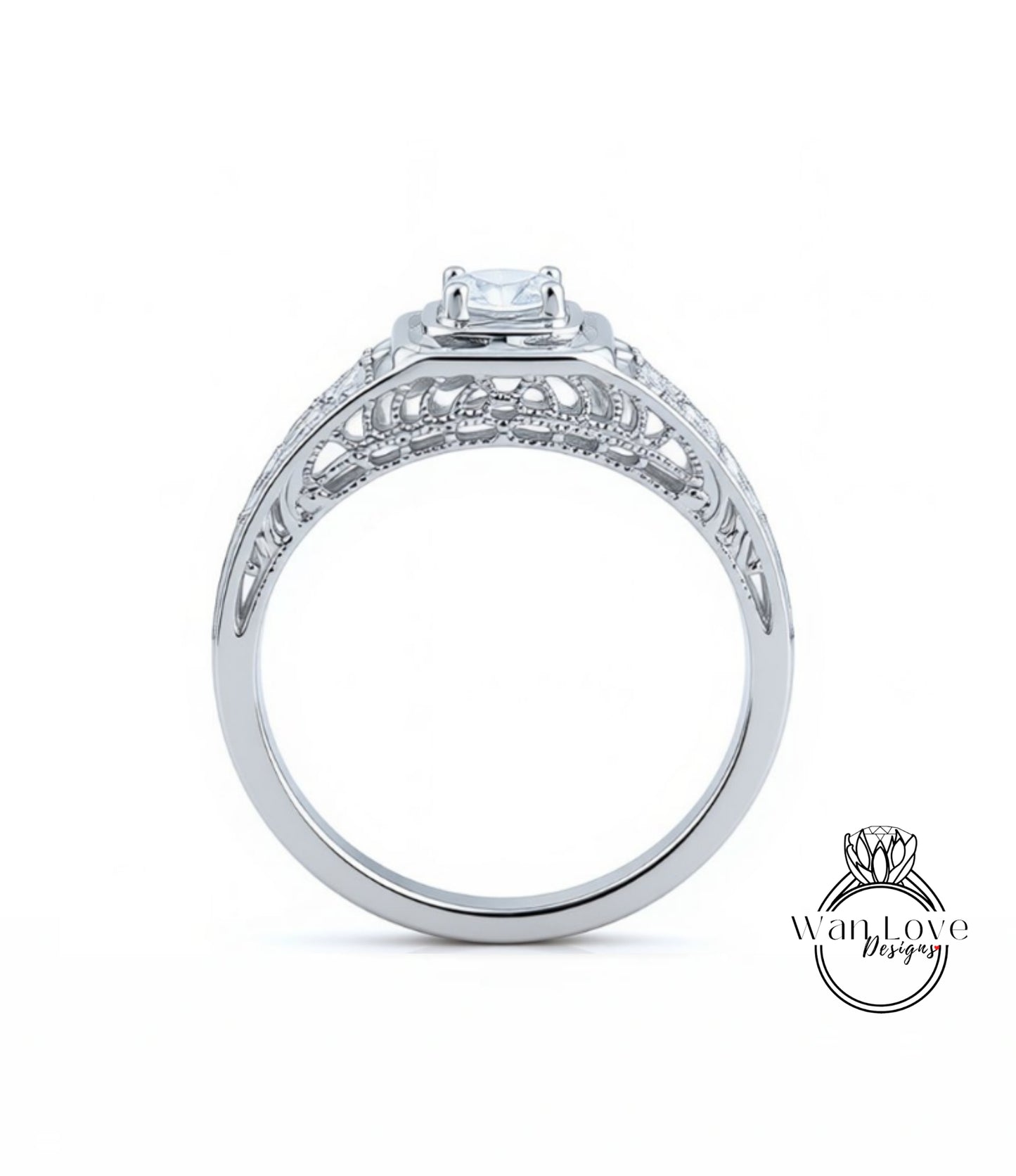 A silver engagement ring with a large central diamond and intricate metalwork detailing.