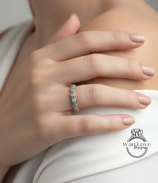 A close-up of a person's hand wearing a diamond ring on the ring finger.