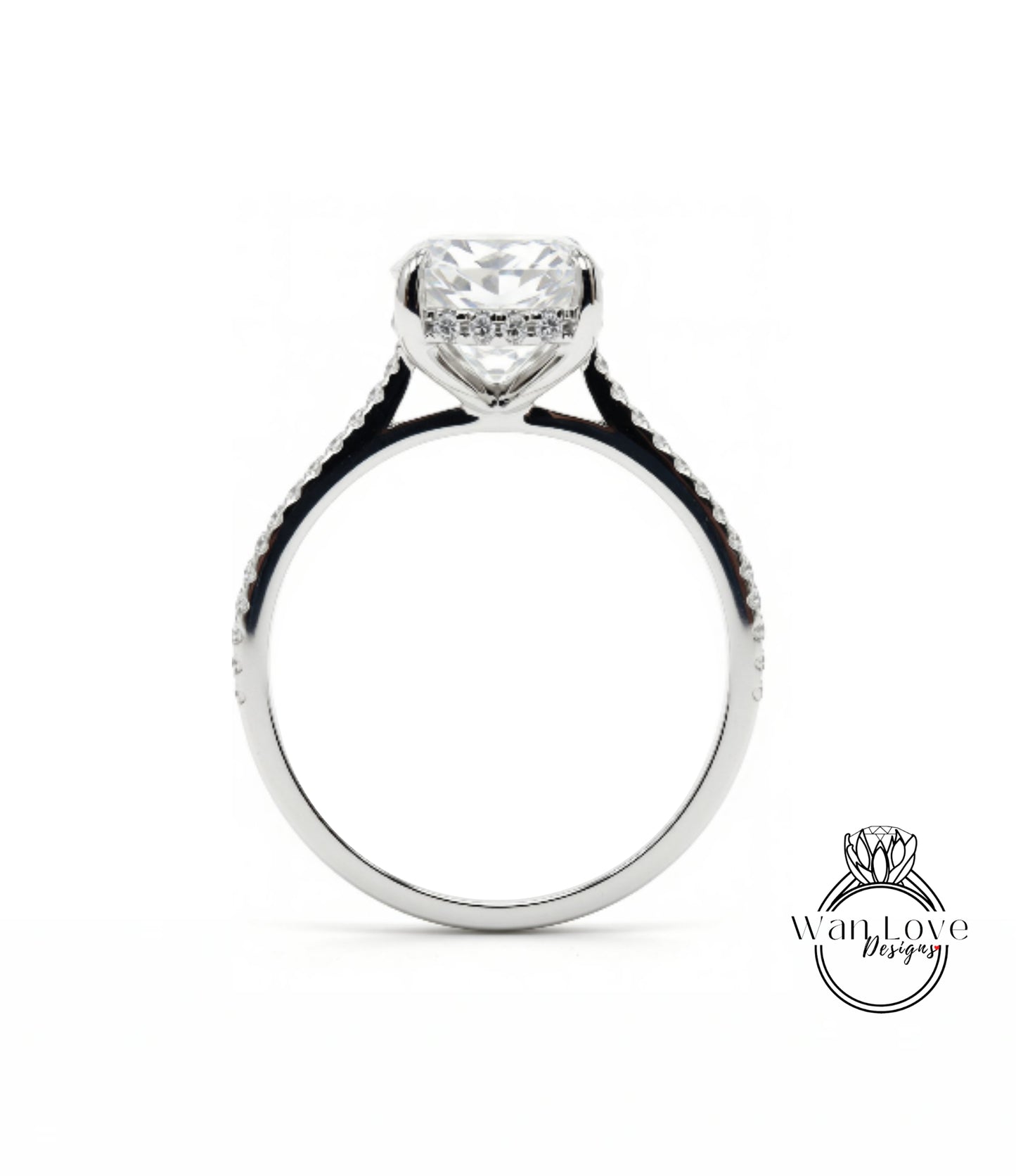 A close-up view of a silver engagement ring with a large, clear gemstone set in the center.