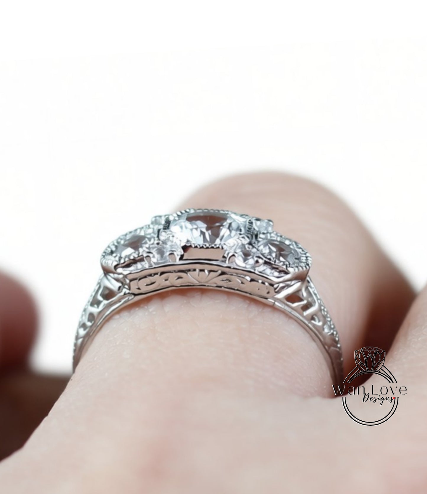 A close-up view of a silver ring with a large central gemstone surrounded by smaller stones.