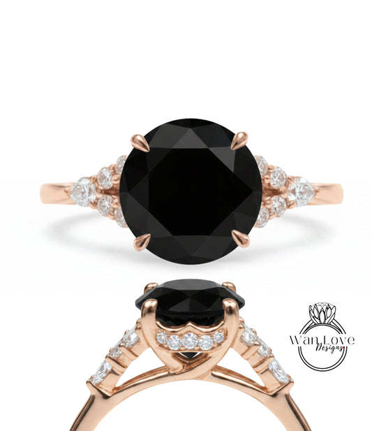 a rose gold engagement ring with a large black diamond as the centerpiece. The ring is adorned with smaller diamonds and has a delicate design.