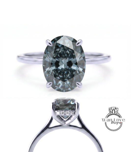 a silver ring with a large oval-shaped diamond as the centerpiece.