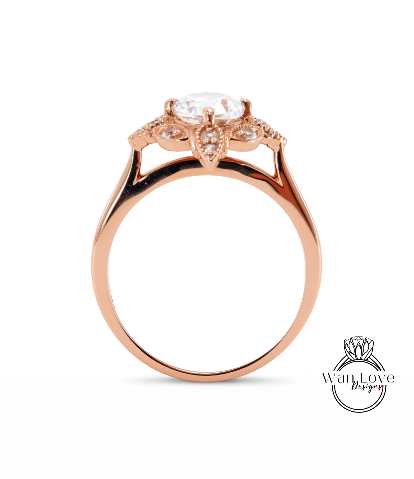 A rose gold engagement ring with a large central diamond surrounded by smaller diamonds, set in a halo of smaller diamonds.