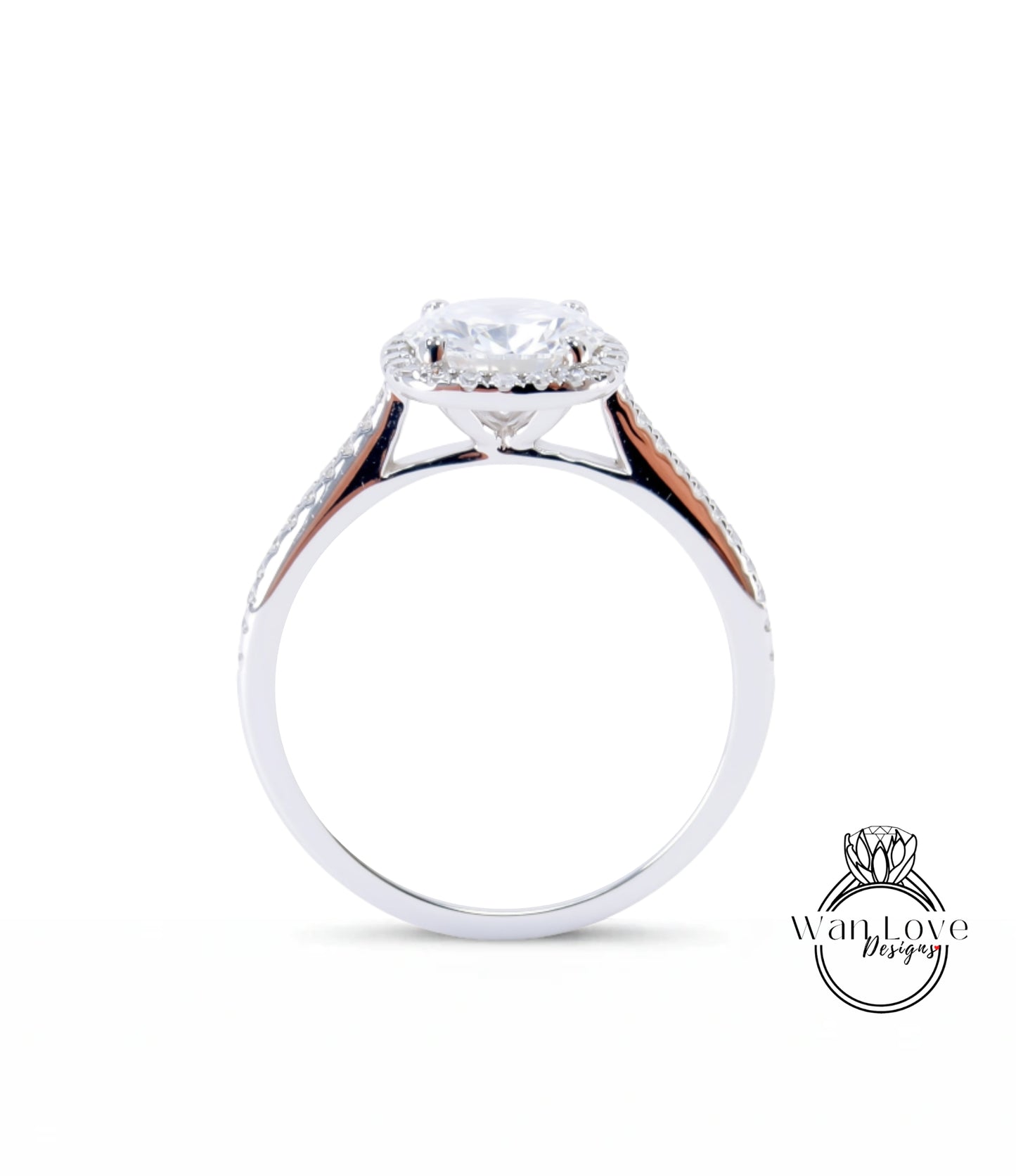 A silver engagement ring with a large central diamond and a halo of smaller diamonds around the center stone.