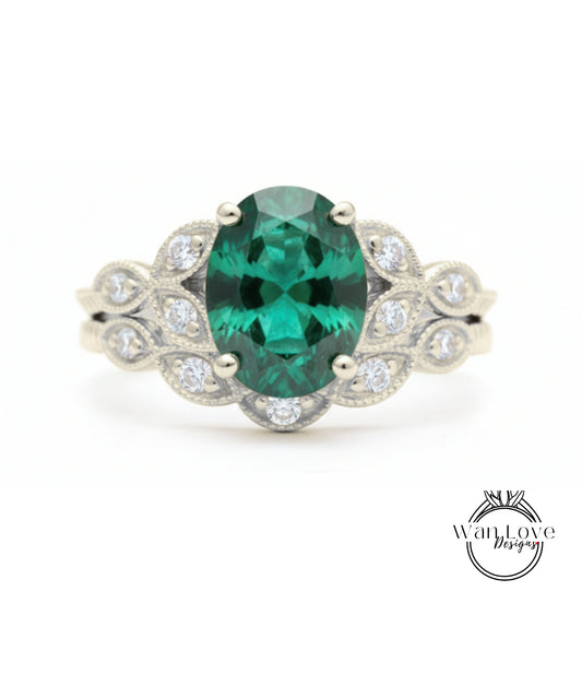 A silver ring with a large oval-shaped green gemstone surrounded by smaller diamonds.