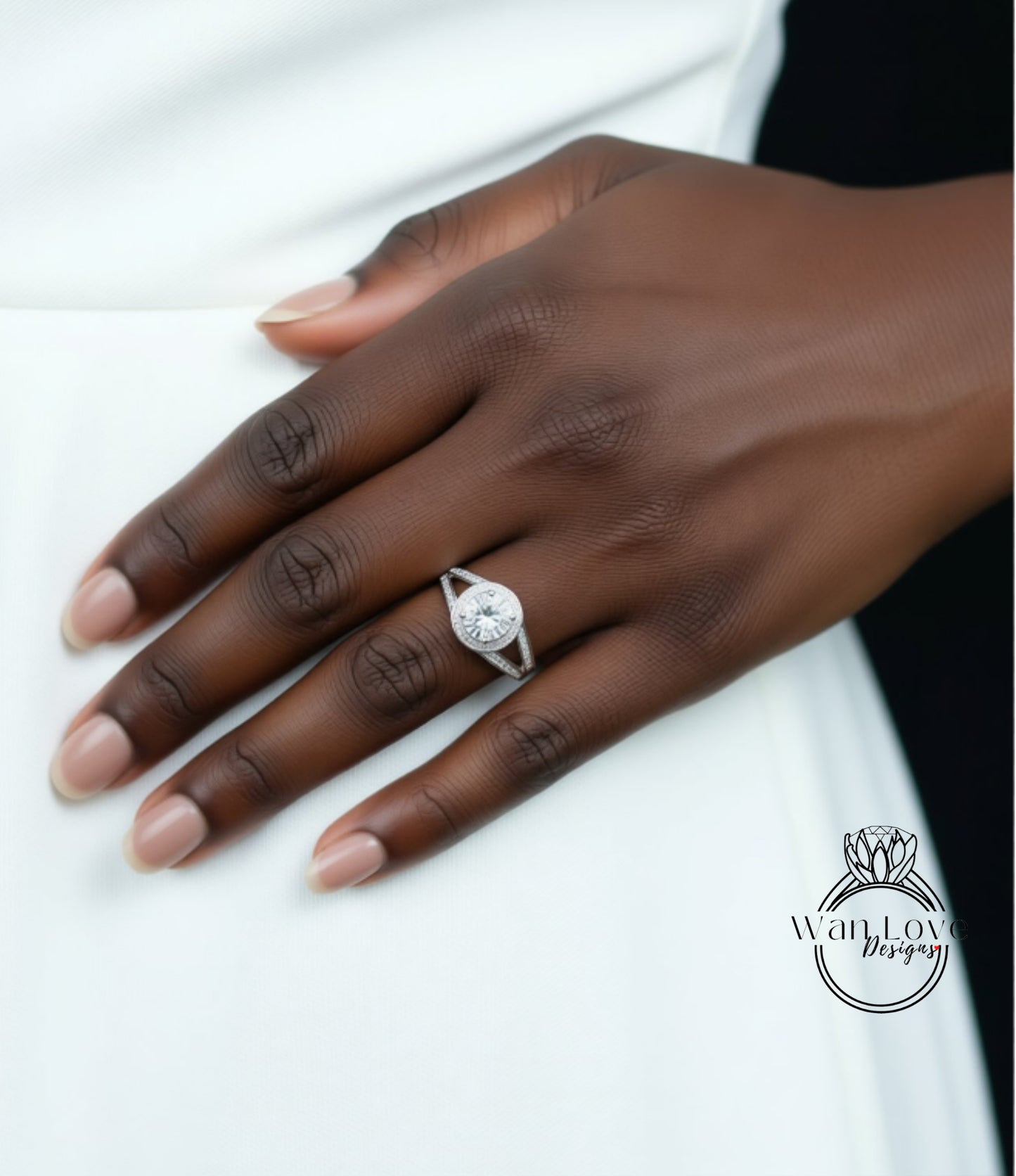 A close-up of a hand wearing a diamond engagement ring.