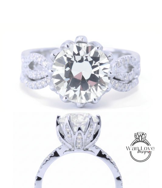 A stunning diamond engagement ring with a large round brilliant cut diamond set in a silver band adorned with smaller diamonds.