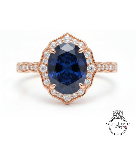 a beautiful rose gold ring with a large oval-shaped blue gemstone set in the center, surrounded by smaller diamonds.