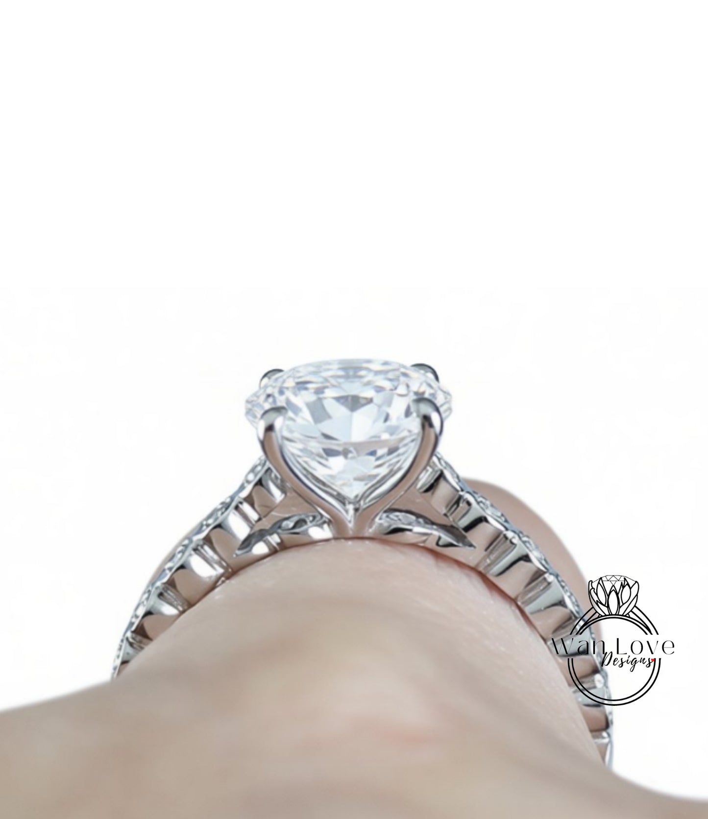 A close-up view of a diamond engagement ring on a person's hand, showcasing the large central diamond surrounded by smaller diamonds on the band.