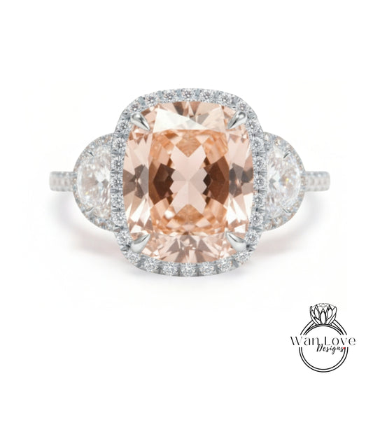 A large, oval-shaped pink gemstone set in a halo of smaller diamonds, surrounded by a halo of smaller diamonds, creating a stunning engagement ring.