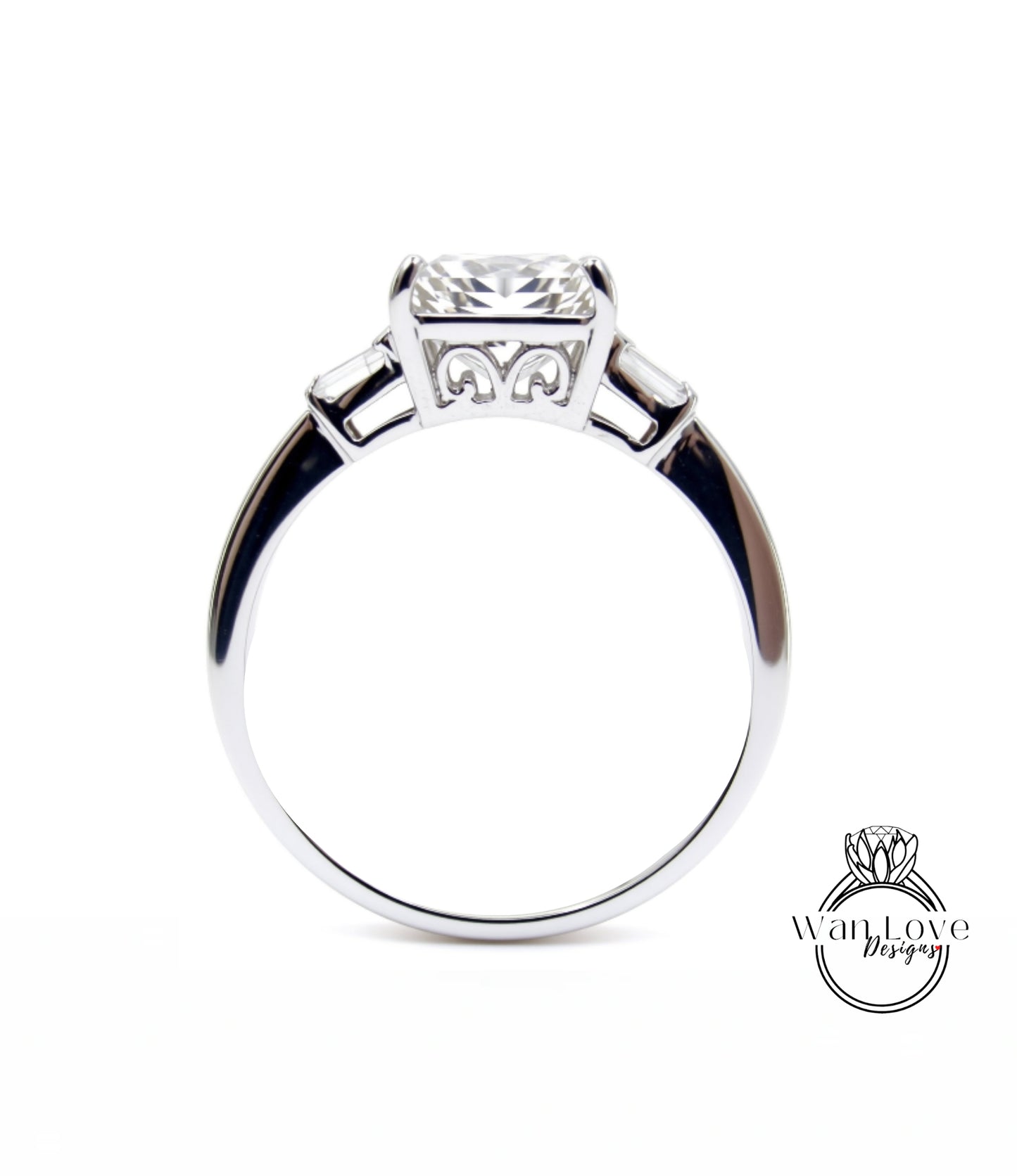 A silver engagement ring with a large central diamond and three smaller diamonds on either side.