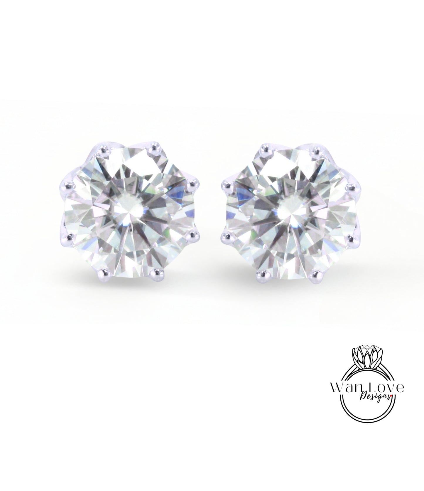 A pair of elegant earrings featuring a large, brilliant-cut diamond set in a silver-colored metal.
