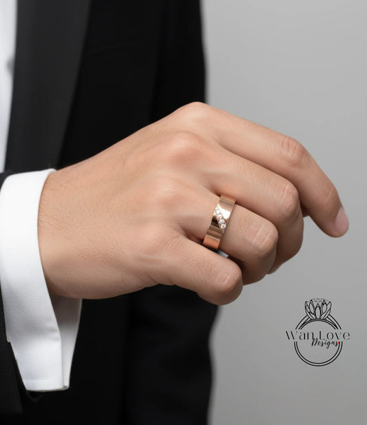 A close-up of a person's hand wearing a gold wedding ring with a diamond.