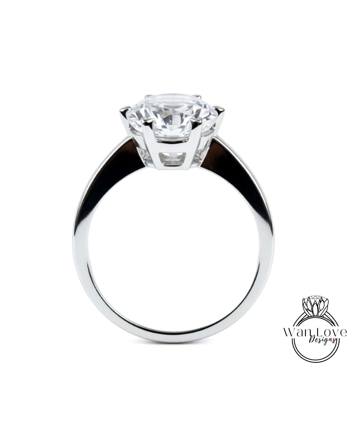 A close-up of a silver ring with a large, clear gemstone set in the center.