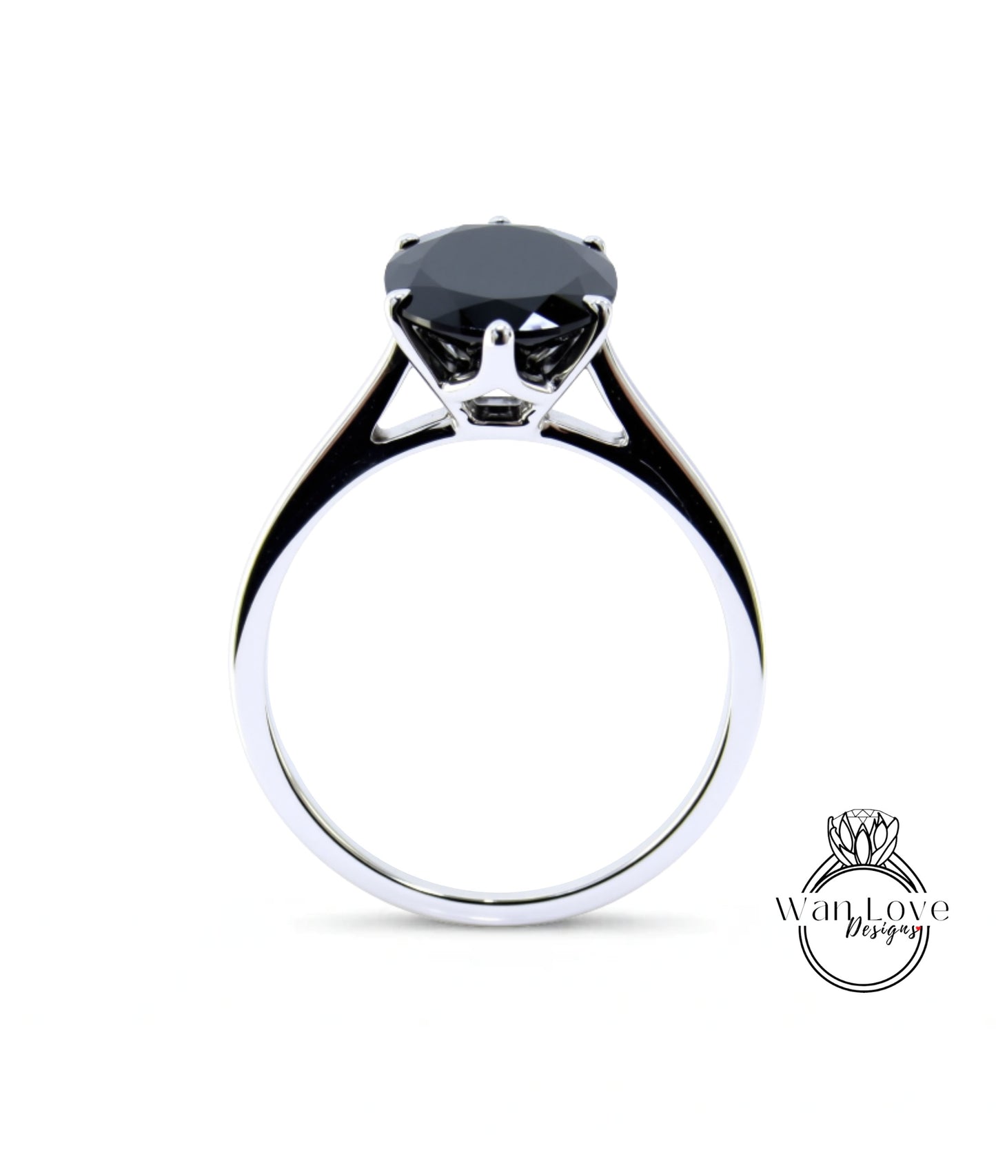 A silver ring with a large black gemstone, likely a diamond, set in the center.