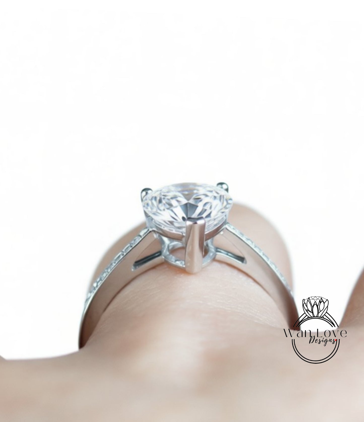 A close-up view of a diamond engagement ring on a person's hand.