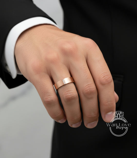 A close-up of a person's hand wearing a gold wedding ring.