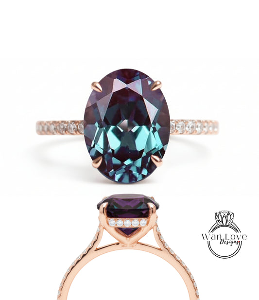 a large, oval-shaped gemstone ring with a gold band and small diamonds.
