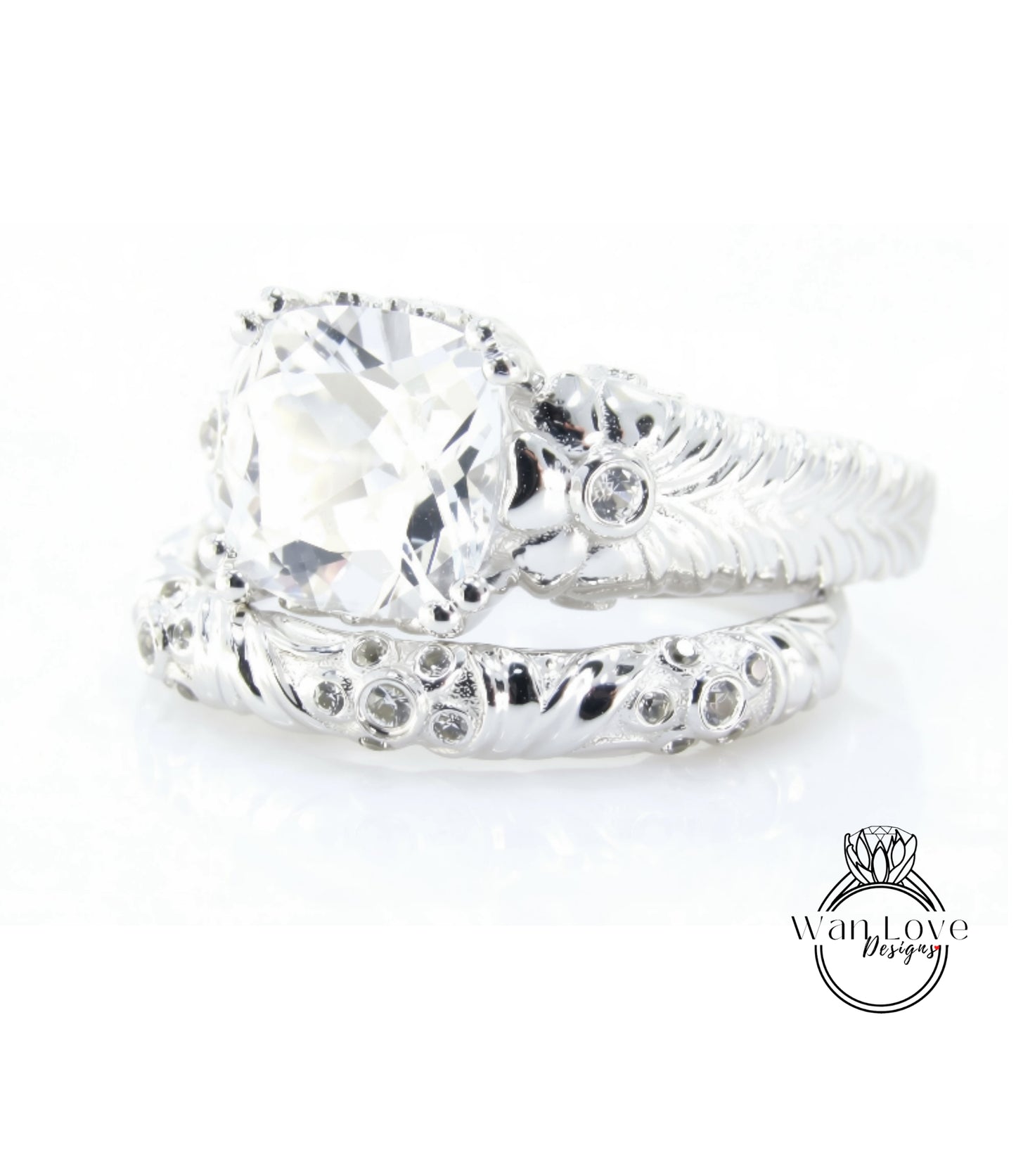 A close-up view of a large, clear gemstone set in a silver ring with intricate designs.