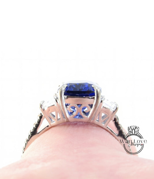 A close-up view of a silver ring with a large blue gemstone, showcasing the intricate design and craftsmanship of the piece.