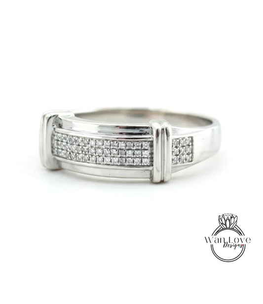 A silver ring with a row of small diamonds set in the band.