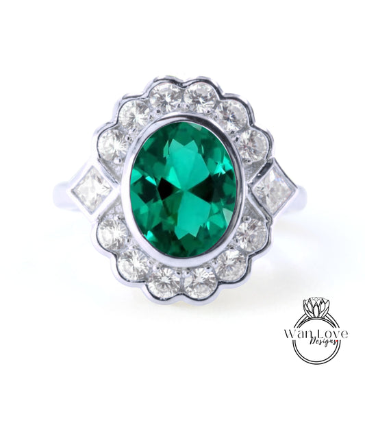 A silver ring with a large oval-shaped green gemstone surrounded by smaller diamonds.