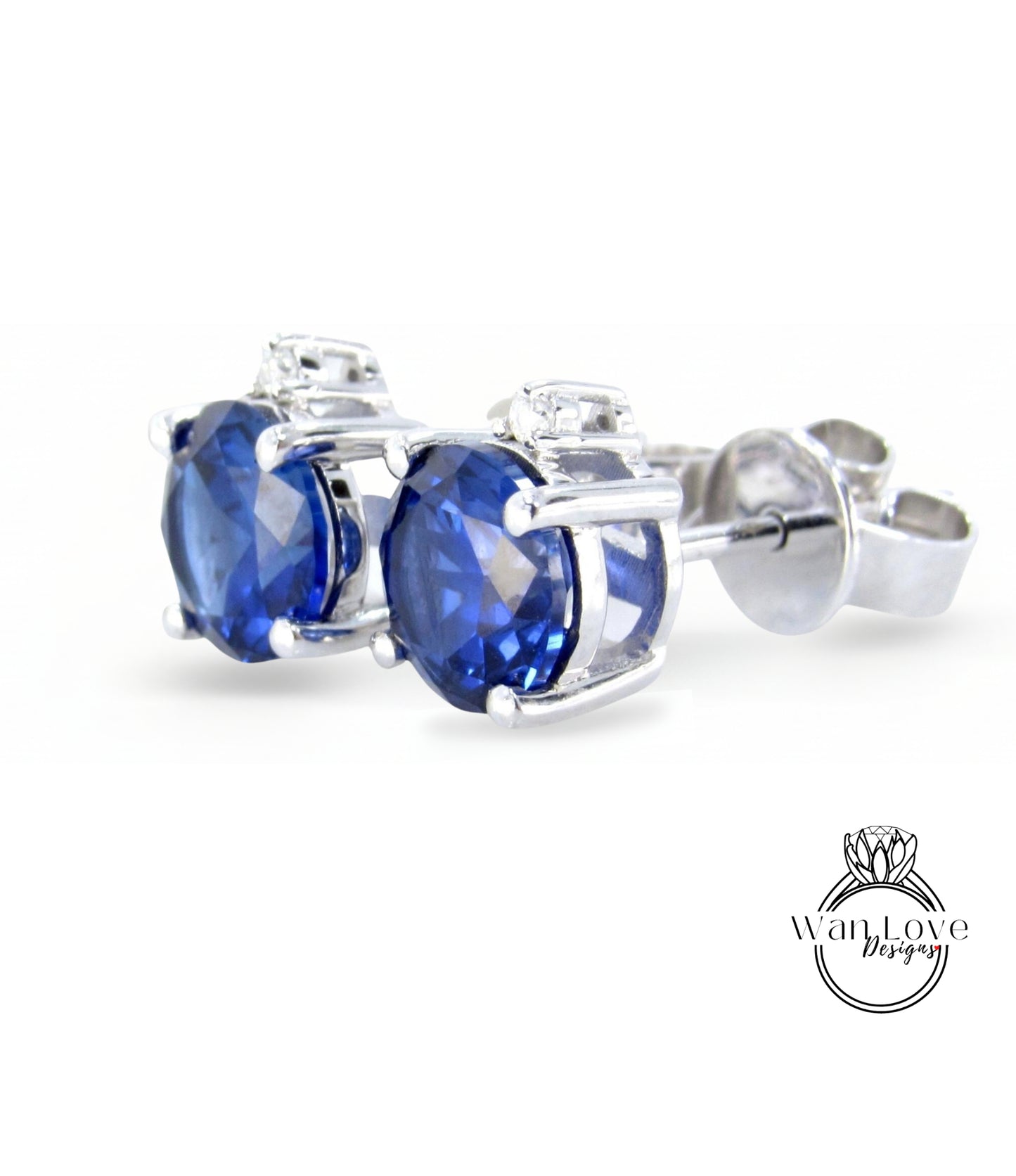 A pair of elegant earrings with blue gemstones, likely sapphires, set in a silver metal frame.