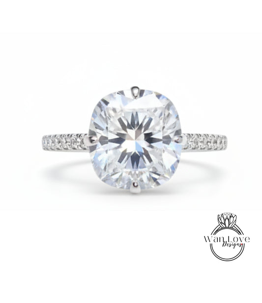 A large, round, brilliant-cut diamond engagement ring with a halo of smaller diamonds around the center stone.