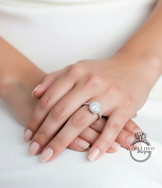 A close-up of a person's hands wearing a diamond engagement ring.