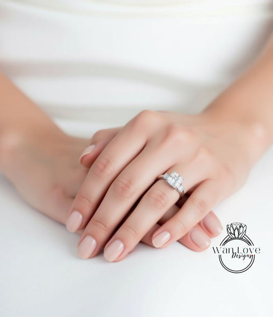 A close-up of a person's hands wearing a diamond engagement ring.