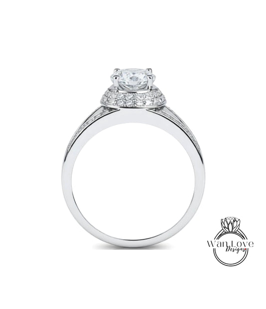 A silver engagement ring with a large central diamond surrounded by smaller diamonds on the band.