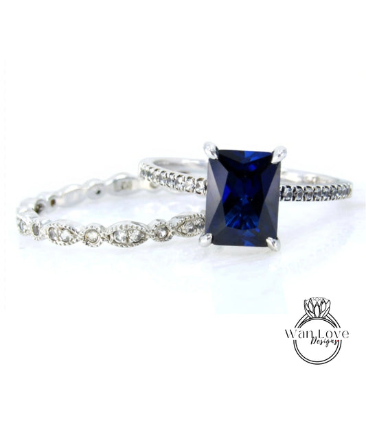 A close-up view of a diamond engagement ring with a large blue gemstone set in a silver band.