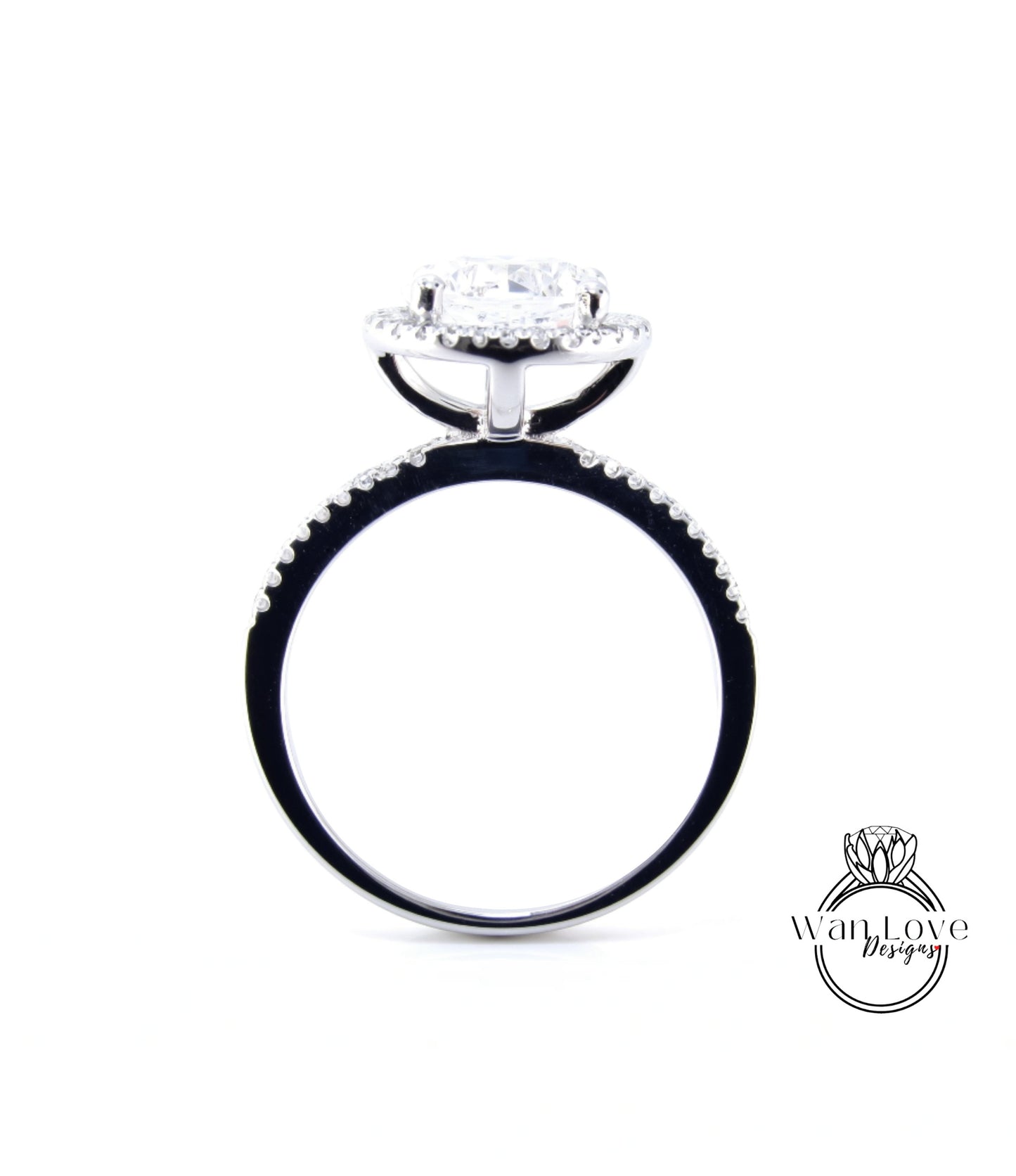 A silver engagement ring with a large central diamond surrounded by smaller diamonds, set in a halo of smaller diamonds.