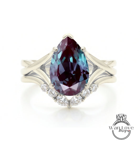 A silver ring with a large, deep purple gemstone at the center, surrounded by smaller diamonds.