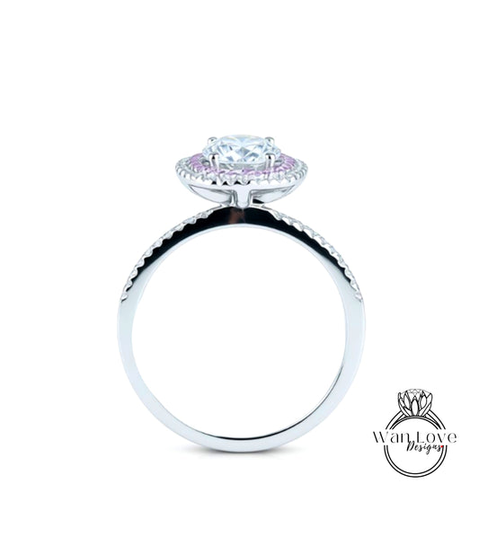 A silver ring with a large, round diamond at the center, surrounded by smaller diamonds.