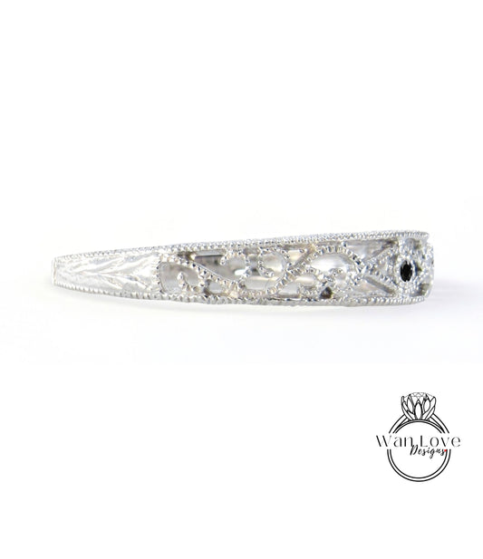 A silver bracelet with a decorative design on it.