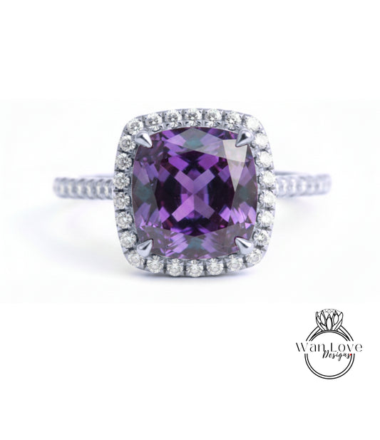 A stunning ring featuring a large, deep purple gemstone surrounded by a halo of sparkling diamonds.